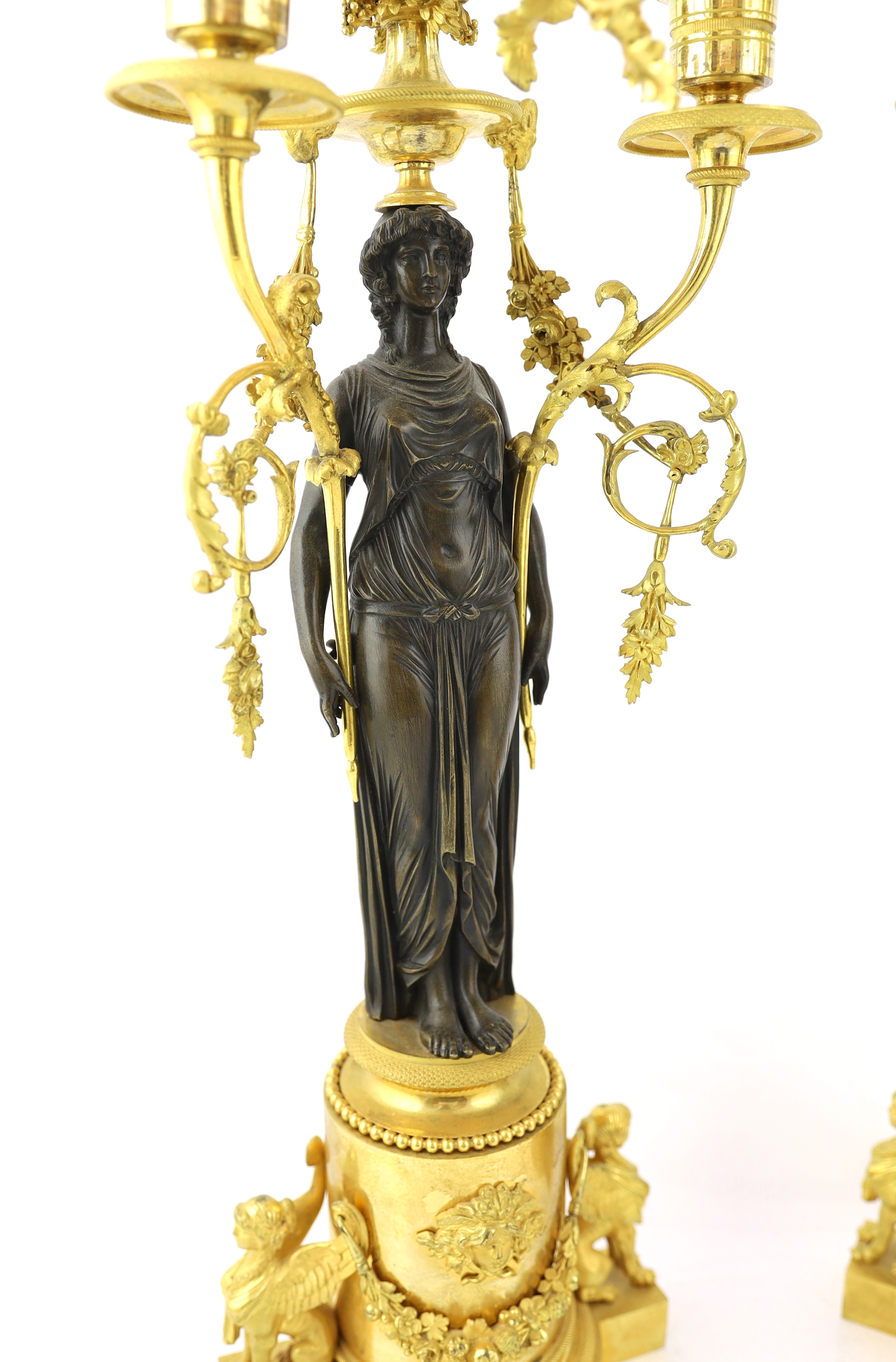 A pair of late 19th century French Empire style bronze and ormolu three light candelabra, 20cm wide, 63cm high, Please note this lot attracts an additional import tax of 5% on the hammer price